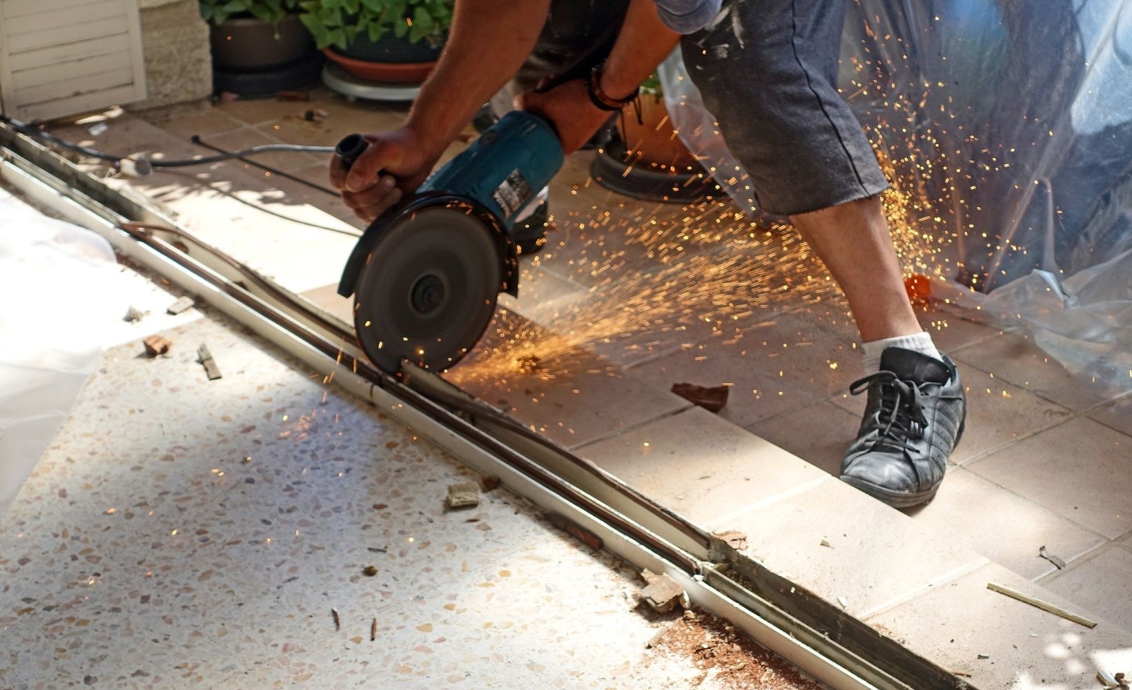 Ein Mitarbeiter/Bauwerksmechaniker zerschneidet alte Materialien.